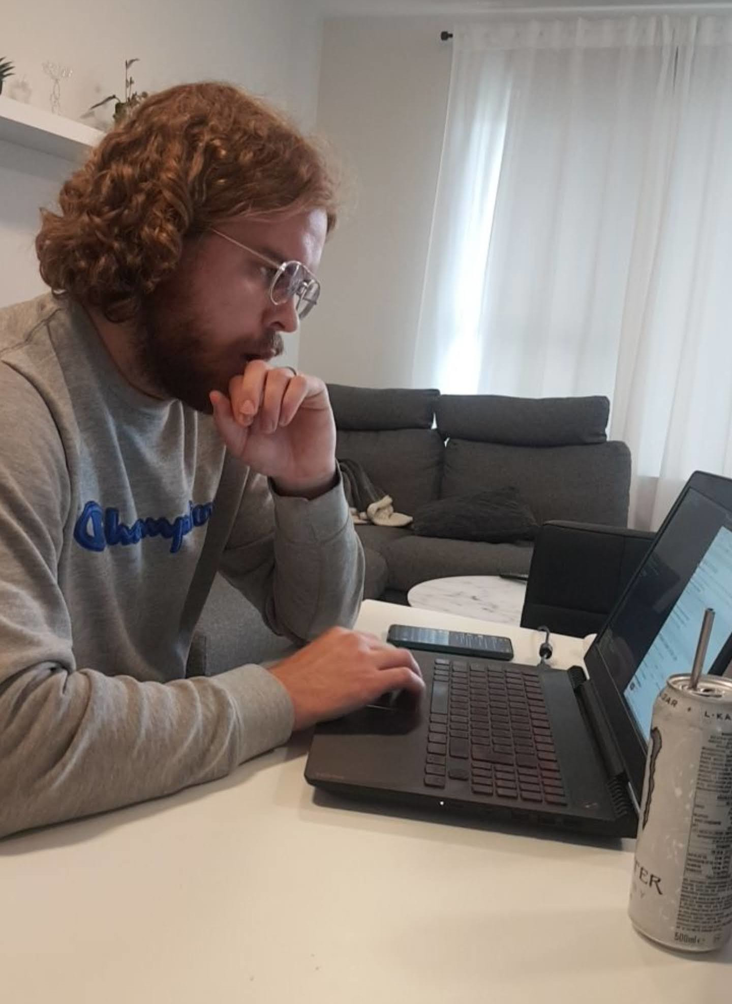 Curly haired Bergur Snorrason at the laptop programming.